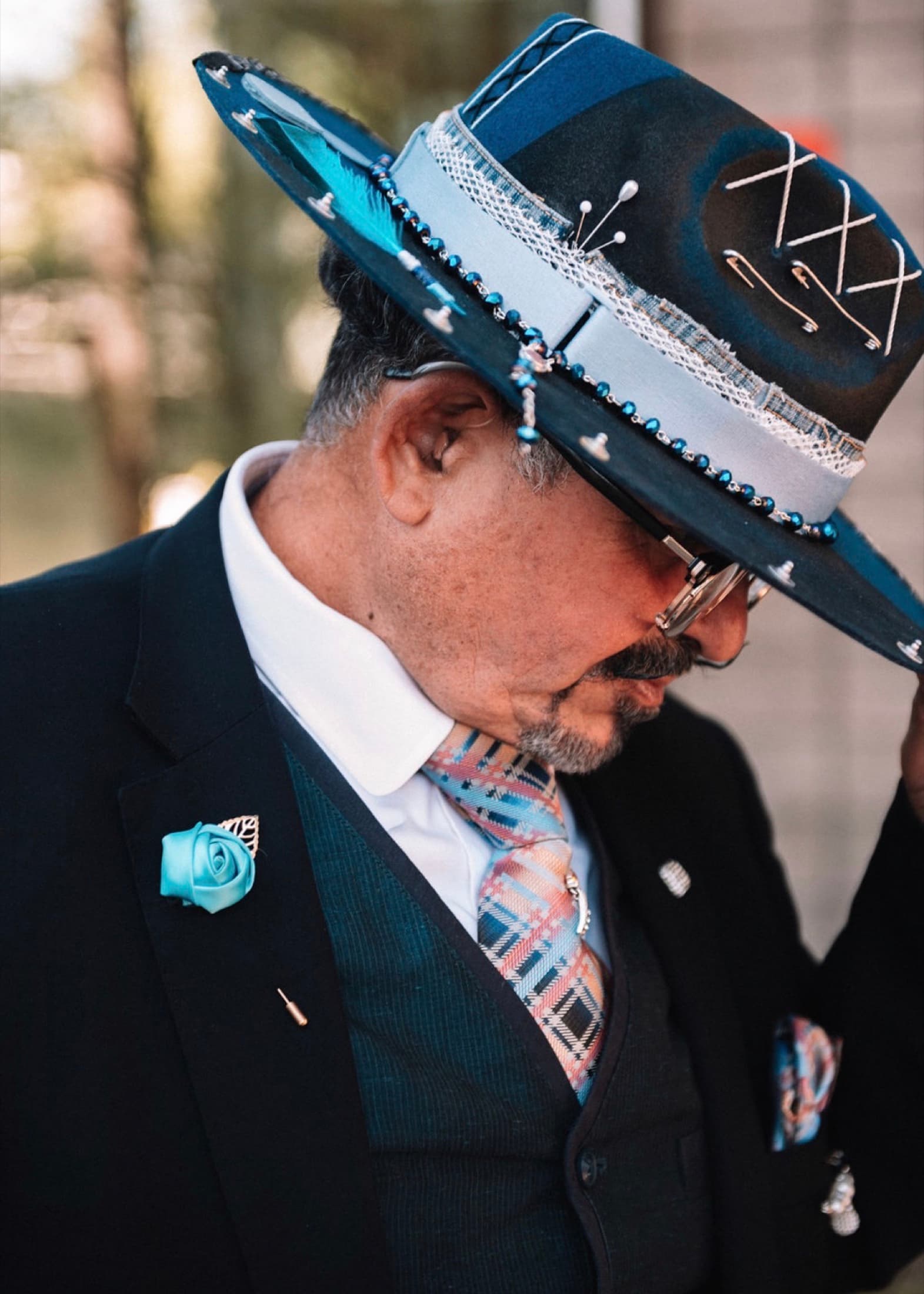 Close-up of Jessy Delgado wearing a blue hand-decorated hat